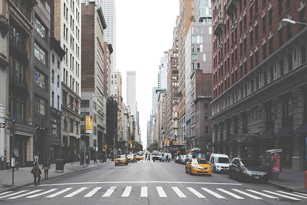 taxi cabs loading on road between high rise.jpg